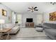 Spacious living room features a large TV and plush sofas with ample seating and a ceiling fan at 1424 Forest Fern Ln, Fuquay Varina, NC 27526