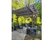 Inviting outdoor patio with a pergola, stone fountain, and comfortable seating area for relaxing or entertaining at 1424 Forest Fern Ln, Fuquay Varina, NC 27526