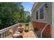 Outdoor back deck with patio furniture, grill, and a view of the wooded yard at 15 Clearwater Harbour Hbr, Sanford, NC 27332