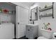 Compact bathroom with a gray vanity, modern fixtures, and convenient laundry closet at 15 Clearwater Harbour Hbr, Sanford, NC 27332