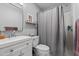 Cozy bathroom featuring a shower with curtain, toilet, and sink with modern fixtures at 15 Clearwater Harbour Hbr, Sanford, NC 27332