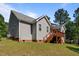 Back exterior showcasing a spacious deck and the home's lovely siding and roof at 15 Clearwater Harbour Hbr, Sanford, NC 27332