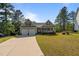 Charming home featuring a two-car garage, inviting front porch, and well-manicured lawn at 15 Clearwater Harbour Hbr, Sanford, NC 27332