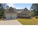 Inviting house with a two-car garage, cozy front porch, and well-maintained green lawn at 15 Clearwater Harbour Hbr, Sanford, NC 27332