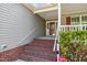 Welcoming front entrance showcasing brick stairs, white railings, and decorative siding at 15 Clearwater Harbour Hbr, Sanford, NC 27332