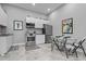 Modern kitchen featuring stainless steel appliances, white cabinets, and a cozy dining area at 15 Clearwater Harbour Hbr, Sanford, NC 27332