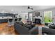 Open-concept living room with a fireplace, modern furnishings, and seamless flow to kitchen at 15 Clearwater Harbour Hbr, Sanford, NC 27332