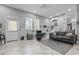 Spacious living space with tile floors, seating, natural light, and stairs to another level at 15 Clearwater Harbour Hbr, Sanford, NC 27332