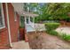 Small back porch featuring white railings and access to basement at 1502 Washington St, Durham, NC 27701