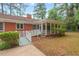 Landscaped backyard with a ramp and enclosed sunroom at 1502 Washington St, Durham, NC 27701