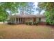 Sprawling backyard with mature trees and an enclosed sunroom at 1502 Washington St, Durham, NC 27701