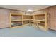 Finished basement with open shelves and brick accent wall at 1502 Washington St, Durham, NC 27701
