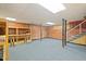 Finished basement with brick wall, shelves and carpet at 1502 Washington St, Durham, NC 27701