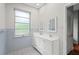 Bathroom with double vanity, natural light and tiled floor at 1502 Washington St, Durham, NC 27701