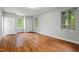 Spacious bedroom with hardwood floors and natural light from three windows at 1502 Washington St, Durham, NC 27701