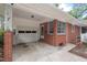 Attached carport featuring brick pillars and a white garage door at 1502 Washington St, Durham, NC 27701
