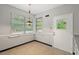Sunlit eat-in kitchen features two windows, gray walls, pendant lighting, and a door to the exterior at 1502 Washington St, Durham, NC 27701