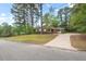 Charming single-story home with mature trees, a well-manicured lawn, and a long driveway at 1502 Washington St, Durham, NC 27701