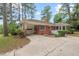 Charming brick home features an attached carport, a driveway, and mature trees at 1502 Washington St, Durham, NC 27701