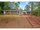 Charming brick home featuring a bay window, manicured lawn, and inviting red brick staircase at 1502 Washington St, Durham, NC 27701