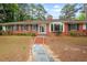 Charming brick home featuring a bay window and meticulously maintained landscaping at 1502 Washington St, Durham, NC 27701
