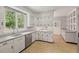 Bright kitchen with white cabinetry, granite countertops, and stainless steel appliances at 1502 Washington St, Durham, NC 27701