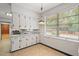 Bright kitchen with lots of cabinet space and vintage pendant lighting with a view of the backyard at 1502 Washington St, Durham, NC 27701