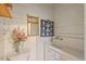 Bright laundry room features a vintage sink, decorative mirror, and fresh white paint at 1502 Washington St, Durham, NC 27701