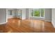 Bright living room boasts hardwood floors and large window with green tree views at 1502 Washington St, Durham, NC 27701
