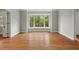 Bright living room boasts hardwood floors, bay window and freshly painted gray walls at 1502 Washington St, Durham, NC 27701