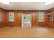 Living room highlighting wood paneling, windows, and built-in shelving at 1502 Washington St, Durham, NC 27701