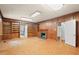 Living room showcasing wood paneling, built-in shelving, and a fireplace at 1502 Washington St, Durham, NC 27701