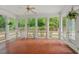 Enclosed sunroom with tile floors and multiple windows offering outdoor views at 1502 Washington St, Durham, NC 27701