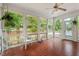 Bright sunroom showcasing tile flooring, ceiling fan, and views of the backyard at 1502 Washington St, Durham, NC 27701