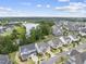 An aerial view of homes in a community overlooking a pond with lush greenery and blue skies at 1605 Silo Point Dr, Wake Forest, NC 27587