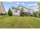 This backyard features a lush lawn with a variety of plants and greenery at 1605 Silo Point Dr, Wake Forest, NC 27587