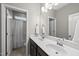 Bright bathroom featuring double sinks, dark cabinets, and a separate toilet and shower at 1605 Silo Point Dr, Wake Forest, NC 27587