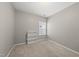 This carpeted bedroom features a sunny window and a built-in bookcase at 1605 Silo Point Dr, Wake Forest, NC 27587