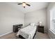 Comfortable bedroom offers neutral colors and carpet, with a desk and large window providing lots of light at 1605 Silo Point Dr, Wake Forest, NC 27587