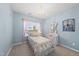 Charming bedroom with chandelier, light-blue walls, and a bright window with sheer pink curtains at 1605 Silo Point Dr, Wake Forest, NC 27587