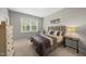 Cozy bedroom with a window letting in natural light, neutral decor, and carpeted floors at 1605 Silo Point Dr, Wake Forest, NC 27587