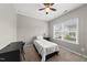 Comfortable bedroom offers neutral colors and carpet, with a desk and large window providing lots of light at 1605 Silo Point Dr, Wake Forest, NC 27587