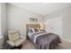 Inviting bedroom with a comfortable chair, carpeted floor, and a double door closet at 1605 Silo Point Dr, Wake Forest, NC 27587
