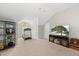 Inviting bonus room includes a treadmill, shelving, and a TV for exercise and entertainment at 1605 Silo Point Dr, Wake Forest, NC 27587