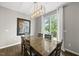 Open dining area with a modern chandelier and access to the outdoor deck at 1605 Silo Point Dr, Wake Forest, NC 27587