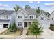 Charming two-story home featuring gray siding, a covered front porch, manicured landscaping and a two-car garage at 1605 Silo Point Dr, Wake Forest, NC 27587