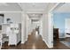 Spacious hallway with beautiful hardwood floors and a view into the living room at 1605 Silo Point Dr, Wake Forest, NC 27587