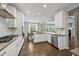 Open-concept kitchen with stainless steel appliances and views of the dining and living areas at 1605 Silo Point Dr, Wake Forest, NC 27587