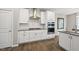 Bright kitchen with stainless appliances, modern backsplash, and white cabinets at 1605 Silo Point Dr, Wake Forest, NC 27587