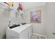 Efficient laundry room with modern washer and dryer, shelving, and neutral walls at 1605 Silo Point Dr, Wake Forest, NC 27587